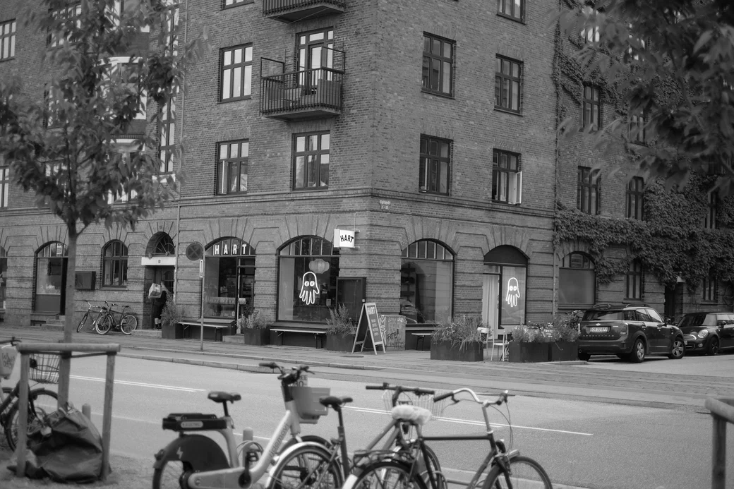 a street corner with bikes and a cafe