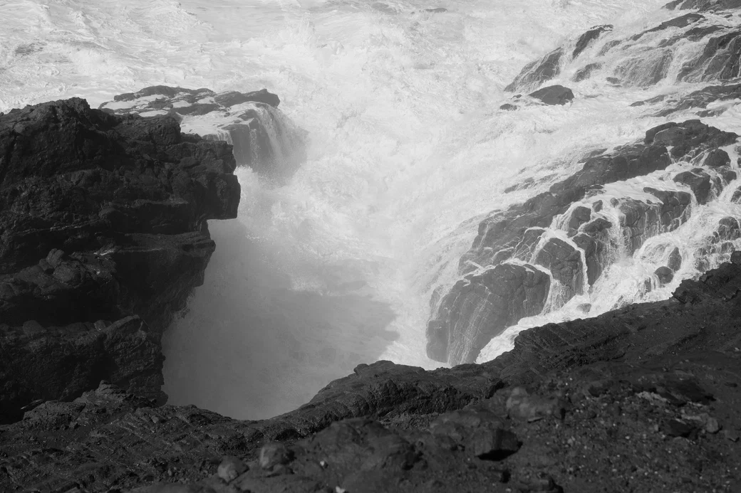 waves breaking between cliffs